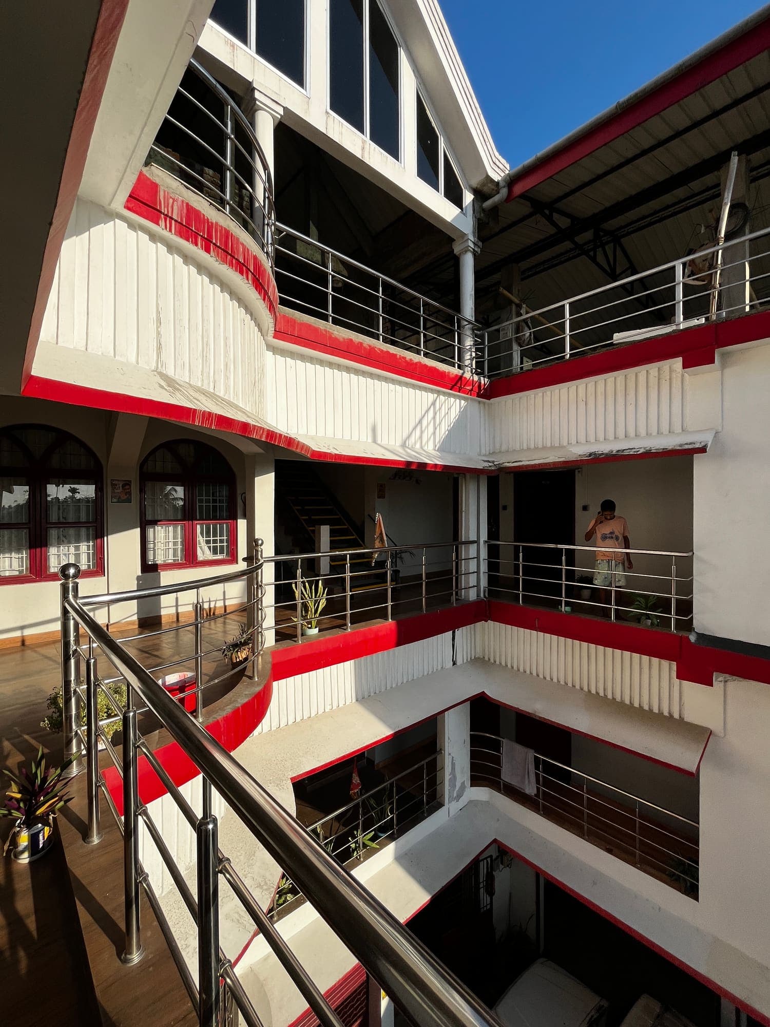 Inner atrium with stacked balconies under a glass-gabled roof